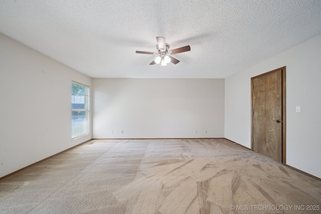 unfurnished room featuring carpet floors, a textured ceiling, ceiling fan, and baseboards