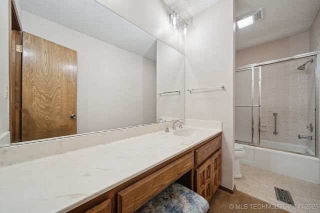 full bathroom featuring visible vents, a textured ceiling, toilet, and vanity