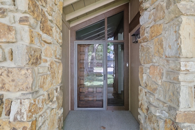 entrance to property with stone siding