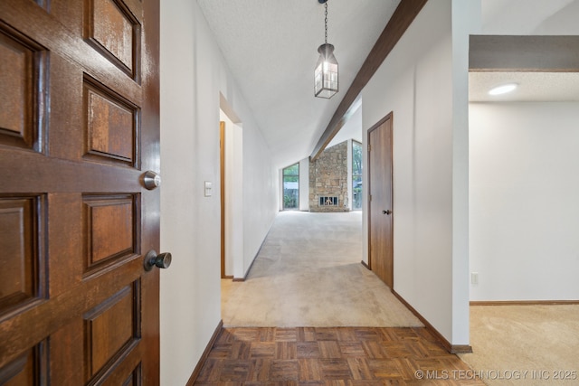 corridor featuring baseboards and dark colored carpet