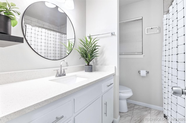 bathroom with vanity, toilet, marble finish floor, baseboards, and a shower with curtain