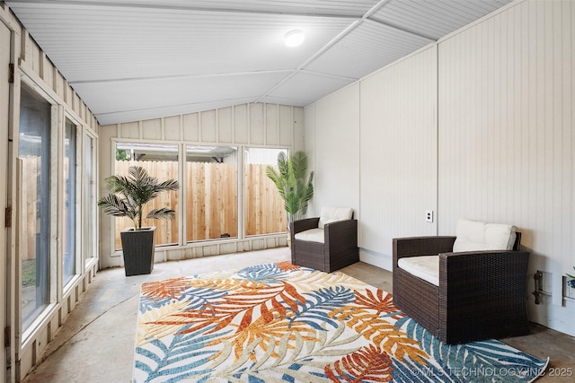interior space featuring concrete floors, plenty of natural light, and lofted ceiling