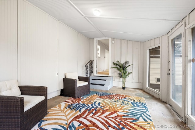 living area with plenty of natural light and concrete flooring