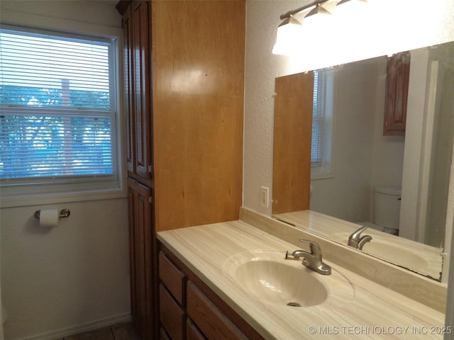 177 Lakeaire Dr, Eufaula, OK 74432 - half bathroom with vanity, plenty of natural light, a textured wall, and toilet