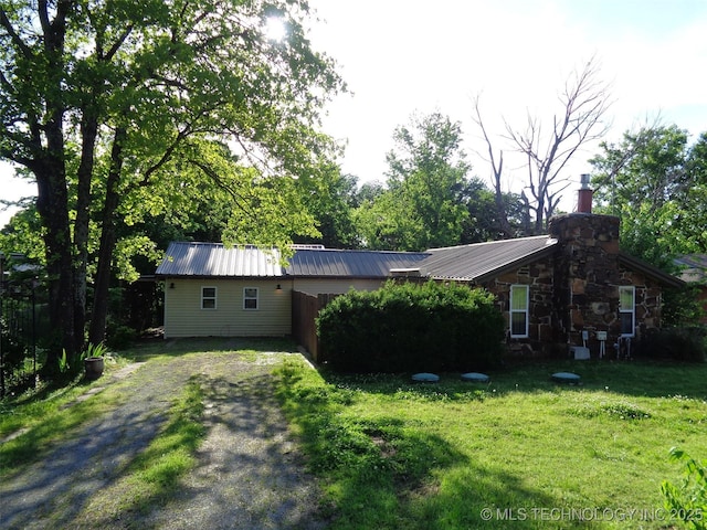 177 Lakeaire Dr, Eufaula, OK 74432 - exterior space with a front lawn, driveway, a chimney, and metal roof