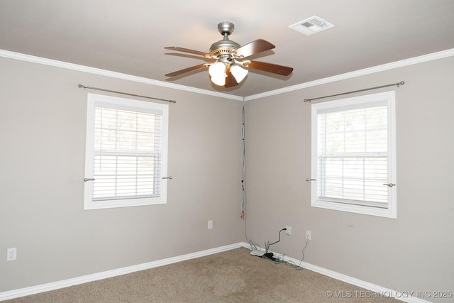 spare room featuring visible vents, plenty of natural light, baseboards, and ceiling fan