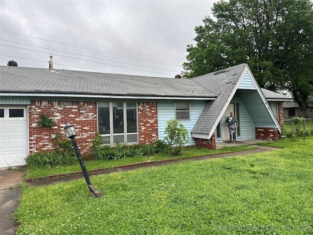 12131 E 31st Pl, Tulsa, OK 74146 - view of front of house featuring brick siding, a front lawn, and a shingled roof