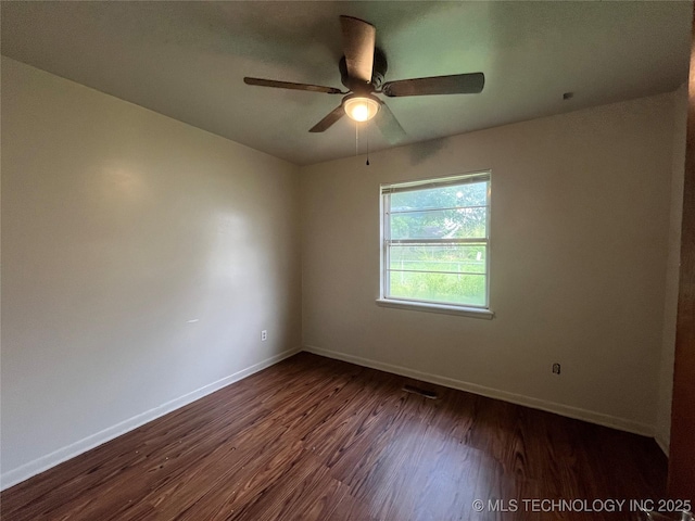 12131 E 31st Pl, Tulsa, OK 74146 - unfurnished room featuring dark wood-style flooring, baseboards, and a ceiling fan