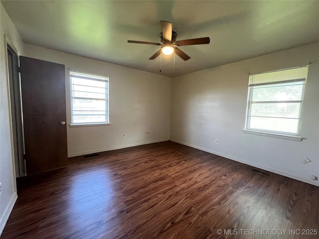 12131 E 31st Pl, Tulsa, OK 74146 - empty room featuring dark wood-type flooring, ceiling fan, and baseboards