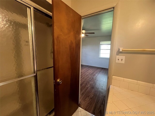 12131 E 31st Pl, Tulsa, OK 74146 - bathroom featuring a stall shower, a ceiling fan, and wood finished floors