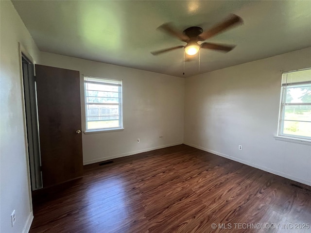 12131 E 31st Pl, Tulsa, OK 74146 - spare room with dark wood-style flooring, healthy amount of natural light, and a ceiling fan