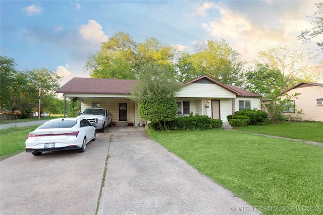 ranch-style house with a carport, driveway, and a front yard