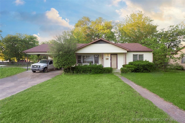 bungalow with driveway, a carport, and a front lawn
