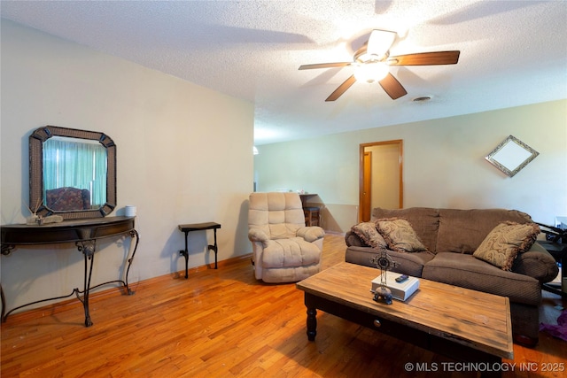 living room featuring a ceiling fan and wood finished floors