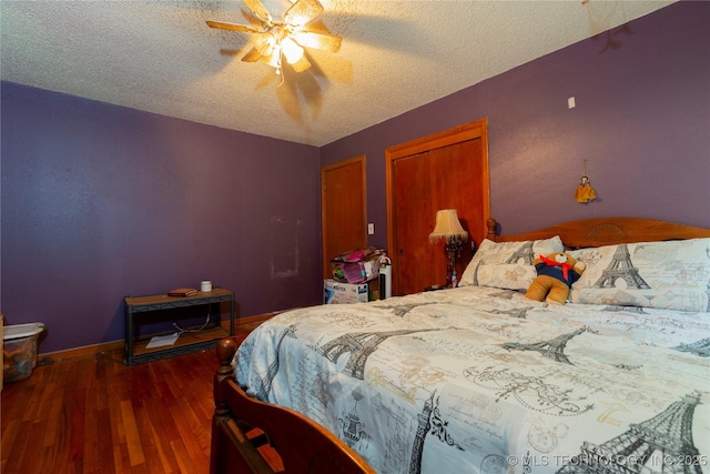 bedroom featuring a textured ceiling, baseboards, a ceiling fan, and wood finished floors