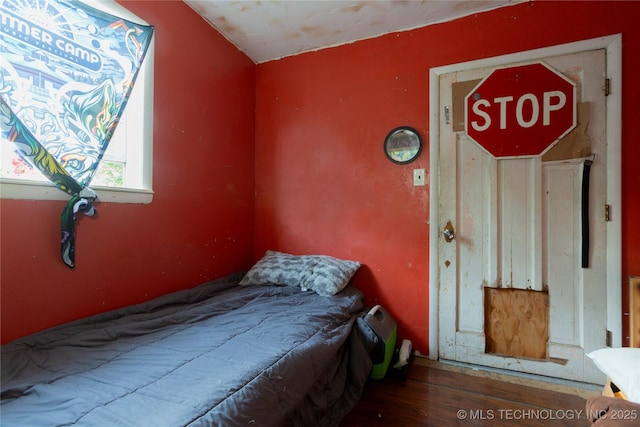 bedroom with wood finished floors