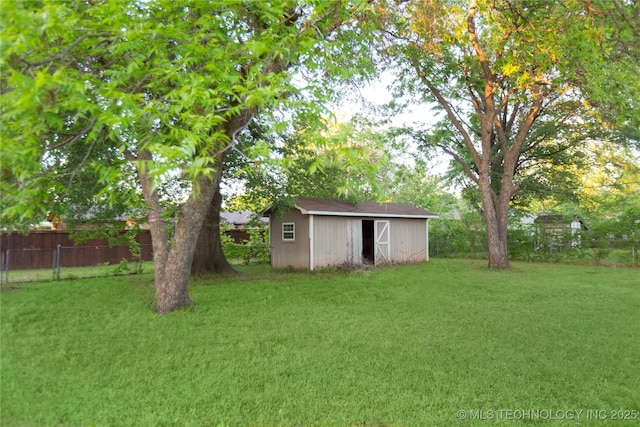 view of yard featuring fence, an outdoor structure, and a shed