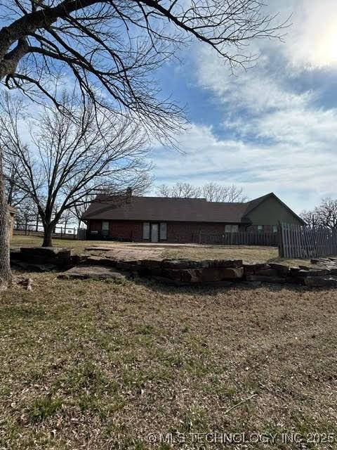 28857 Pea Ridge Dr, Sand Springs, OK 74063 - view of home's exterior with a lawn and fence
