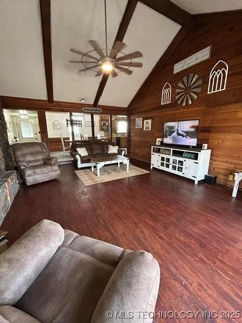 living room featuring wooden walls, ceiling fan, and wood finished floors