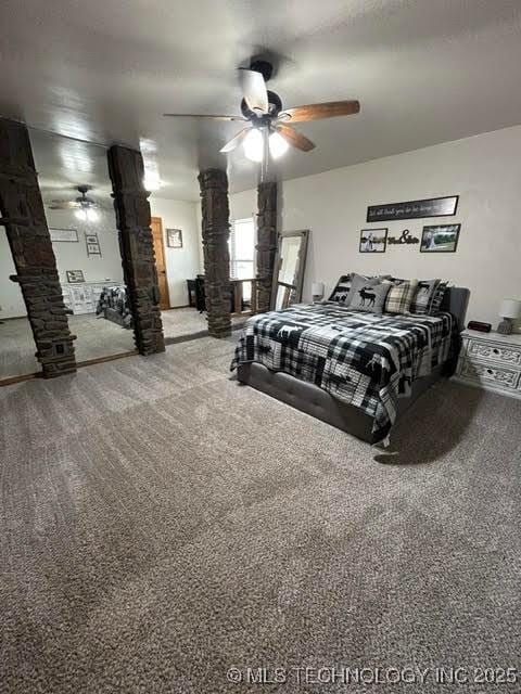 carpeted bedroom featuring decorative columns