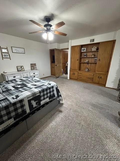 bedroom featuring light colored carpet, a ceiling fan, and visible vents