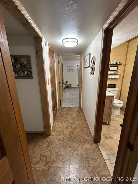corridor with a textured ceiling