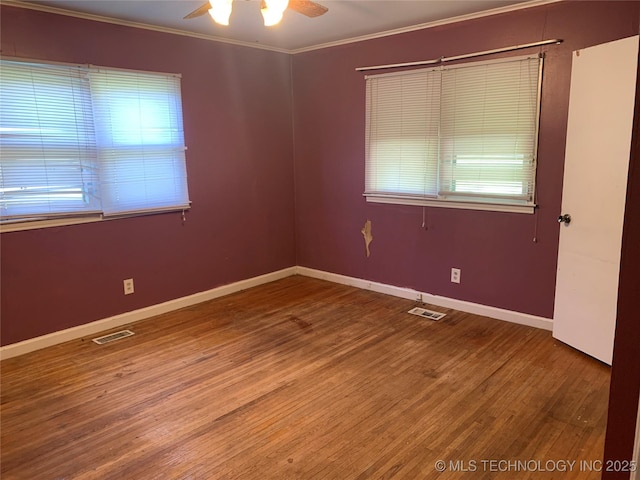 empty room featuring visible vents, a ceiling fan, and a healthy amount of sunlight
