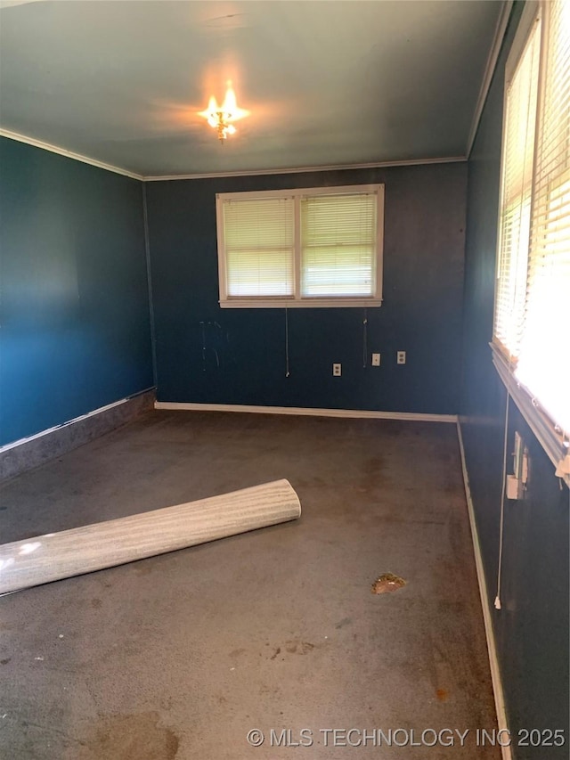 empty room with baseboards, carpet flooring, and ornamental molding