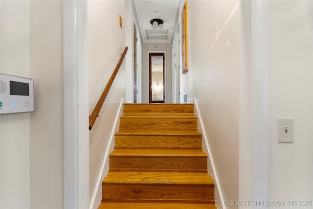 stairway featuring visible vents