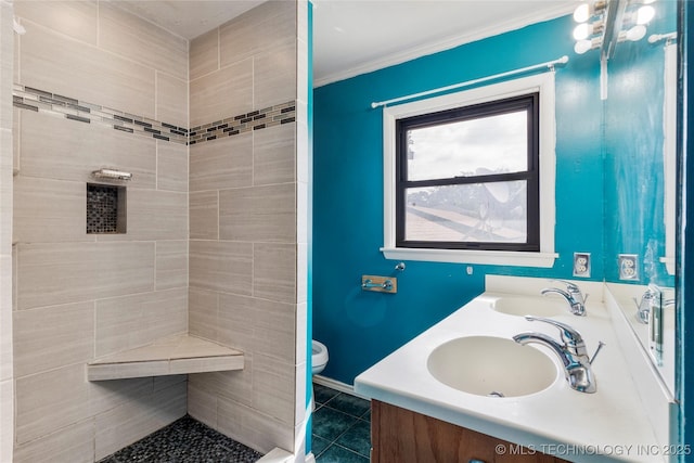 bathroom with tile patterned flooring, a sink, toilet, and tiled shower