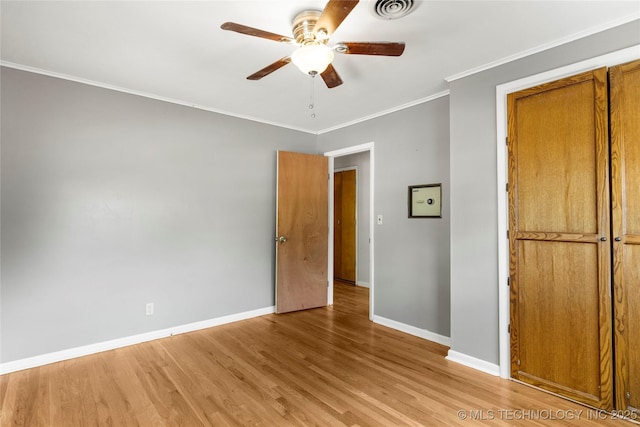 unfurnished bedroom featuring visible vents, crown molding, baseboards, and light wood finished floors