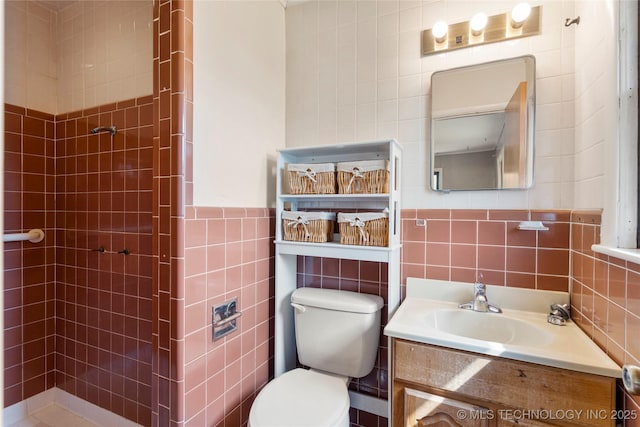 bathroom featuring toilet, tile walls, and a tile shower
