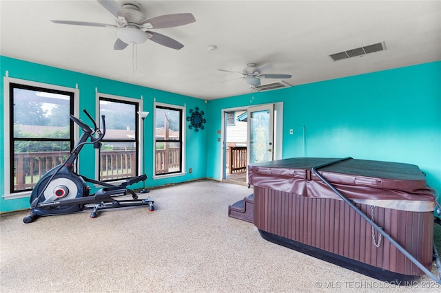 interior space with a ceiling fan, baseboards, and visible vents