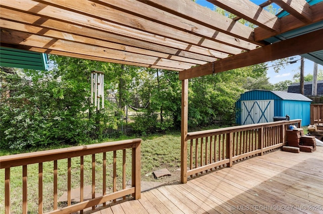 wooden deck with fence, an outdoor structure, a pergola, and a shed
