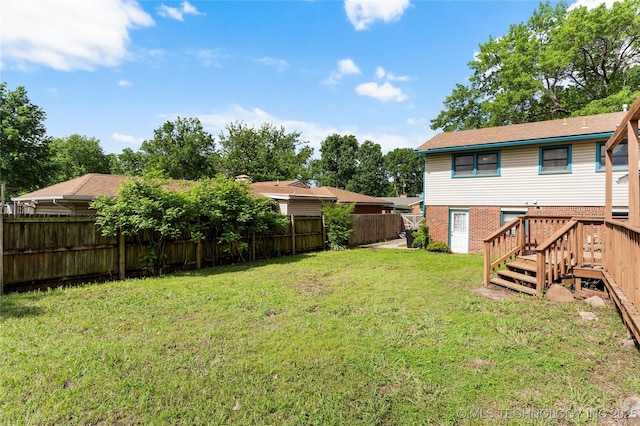 view of yard with a fenced backyard and a deck
