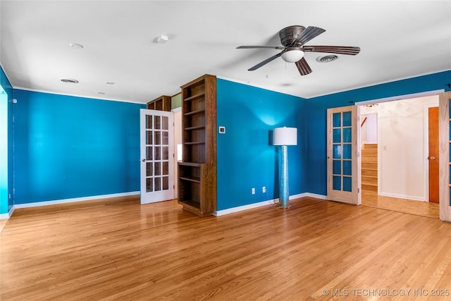 unfurnished room with a ceiling fan, french doors, visible vents, wood finished floors, and baseboards