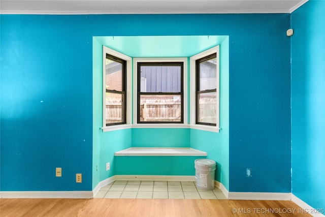 interior space featuring baseboards and wood finished floors