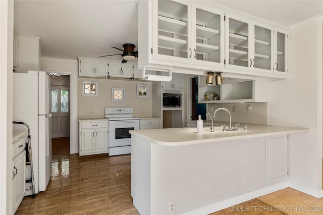 kitchen with white appliances, ceiling fan, glass insert cabinets, and white cabinets