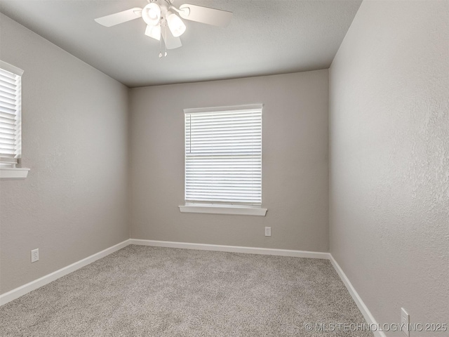 spare room with baseboards, carpet, and ceiling fan