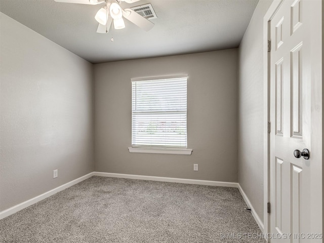 unfurnished room with baseboards, a ceiling fan, carpet flooring, and visible vents