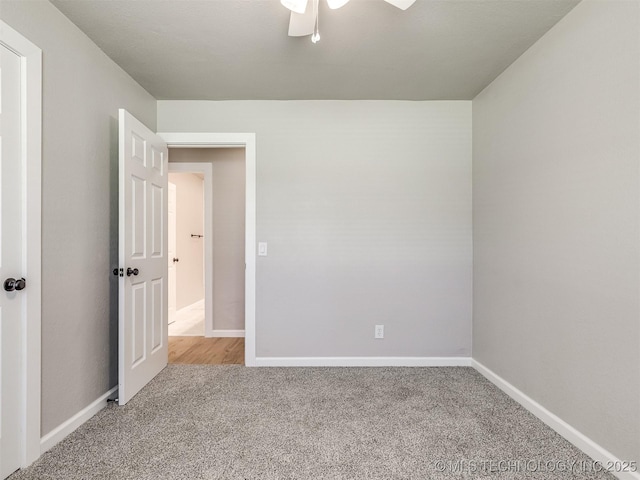 unfurnished bedroom with carpet floors, a ceiling fan, and baseboards