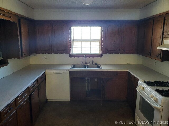 824 W Houston St, Okemah, OK 74859 - kitchen with white appliances, a sink, under cabinet range hood, and light countertops