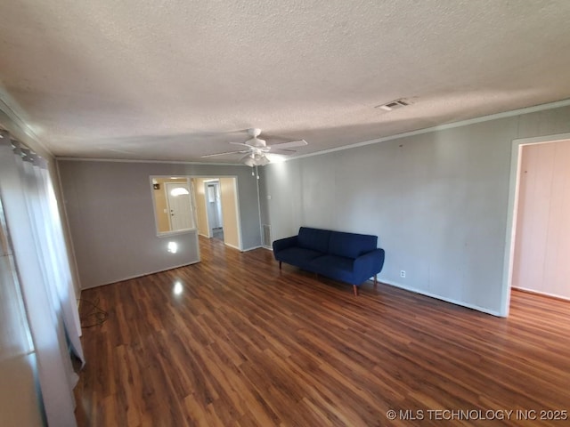 824 W Houston St, Okemah, OK 74859 - unfurnished room with wood finished floors, a textured ceiling, ceiling fan, crown molding, and baseboards
