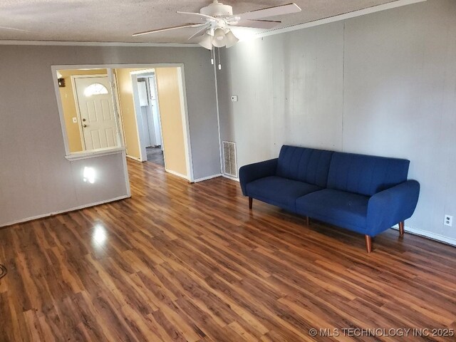 824 W Houston St, Okemah, OK 74859 - sitting room with wood finished floors, ceiling fan, ornamental molding, and baseboards