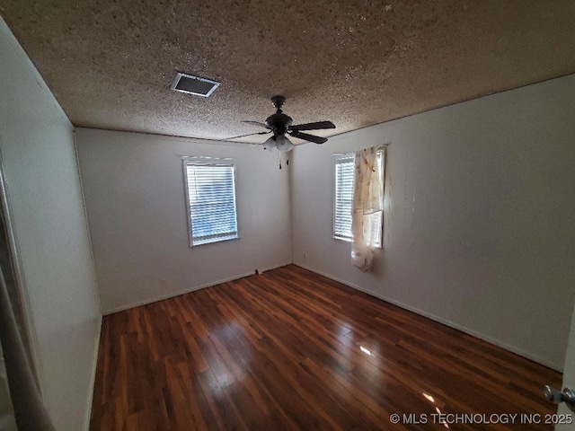 824 W Houston St, Okemah, OK 74859 - unfurnished room featuring wood finished floors, ceiling fan, and a textured ceiling