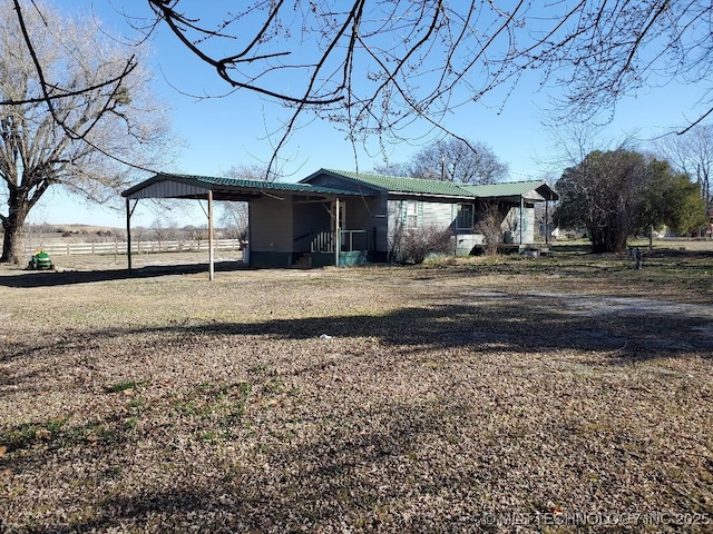 824 W Houston St, Okemah, OK 74859 - view of home's exterior featuring metal roof