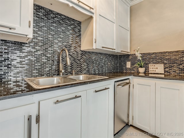 2236 S Marion Ave, Tulsa, OK 74114 - kitchen with backsplash, dark countertops, stainless steel dishwasher, and a sink