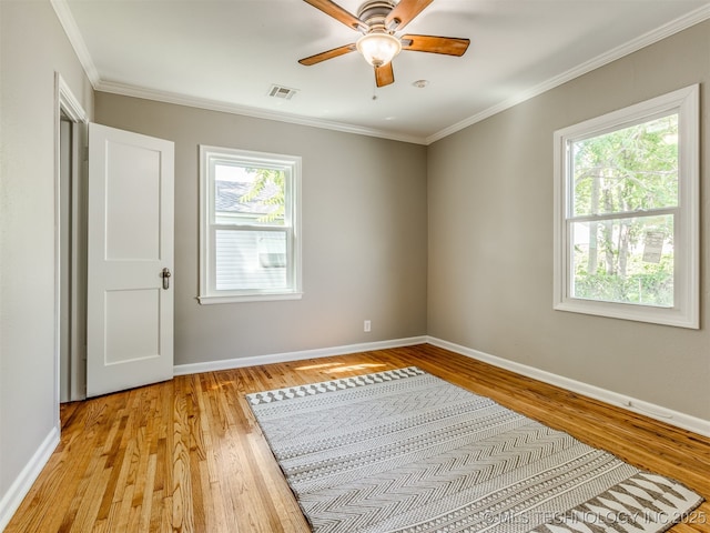 2236 S Marion Ave, Tulsa, OK 74114 - unfurnished bedroom with baseboards, crown molding, light wood-style flooring, and visible vents