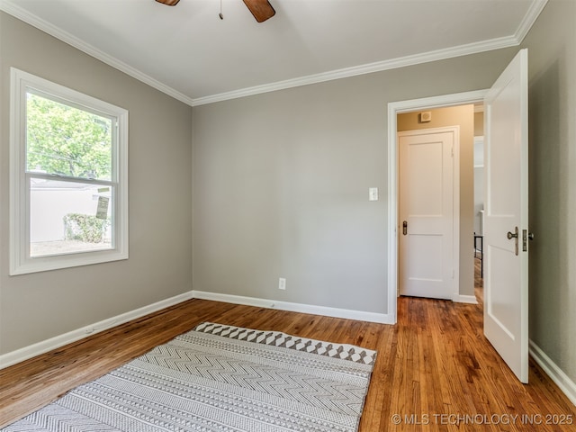 2236 S Marion Ave, Tulsa, OK 74114 - unfurnished bedroom featuring baseboards, ornamental molding, ceiling fan, and wood finished floors
