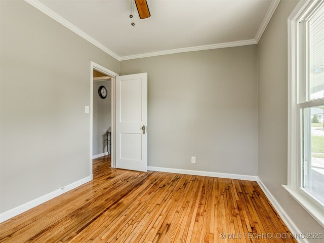 2236 S Marion Ave, Tulsa, OK 74114 - empty room featuring crown molding, baseboards, and light wood-style floors